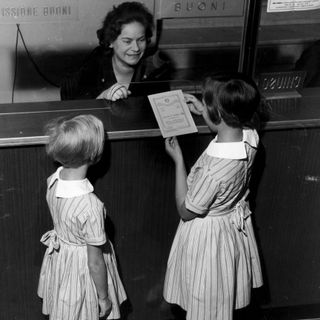 1960: un'impiegata mostra un Libretto di Risparmio Postale