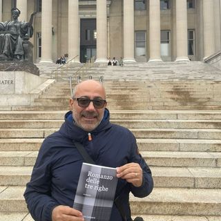 Larganà ritratto con una copia del suo romanzo d'esordio