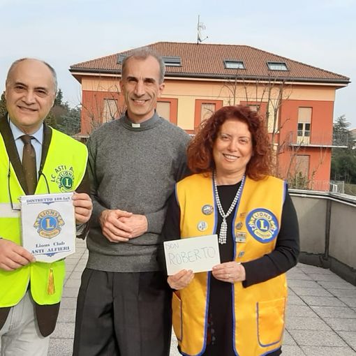 La presidente del Lions Club Asti Alfieri, dottoressa Roberta Pistone, e il cerimoniere Giovanni Boccia insieme a don Roberto, direttore dell'Opera Salesiana di Asti, che riceve parte dell'incasso finalizzate alle attività dell'oratorio