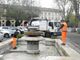 Gli operatori Asp al lavoro per la pulizia della fontana di piazza Alfieri