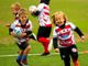 Alcuni bambini ritratti mentre si divertono sul campo del Monferrato Rugby