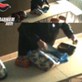 Nel fermo immagine una delle maestre filmata mentre rovista nello zainetto di un allievo per mangiare la merenda preparata per lui dalla mamma